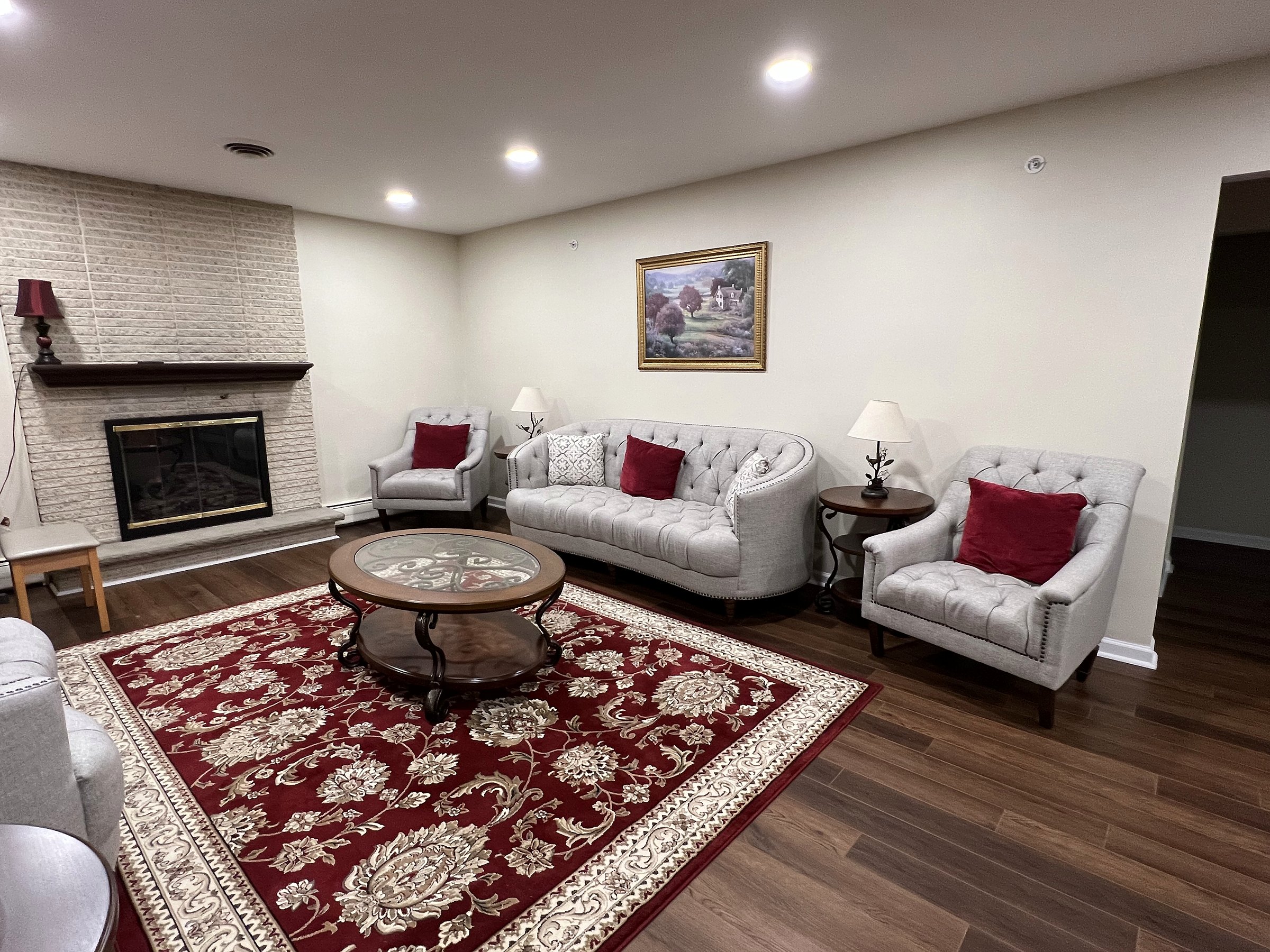The living room at Aria House, with a fireplace and seating